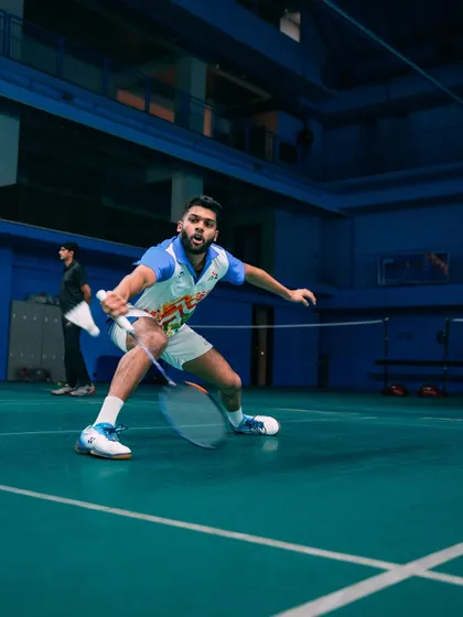 A dynamic defensive stance. The blur of the racket shows the speed and precision our players develop through consistent practice and expert coaching.