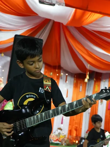 A young guitarist completely lost in the music. This picture captures the passion and focus we instill in our students.