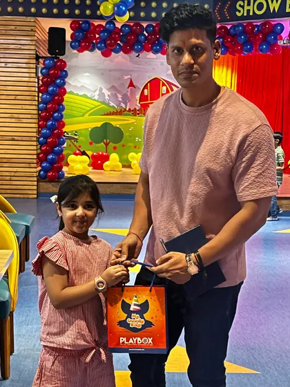A guest receives a goody bag from our staff, a perfect end to a fun visit.