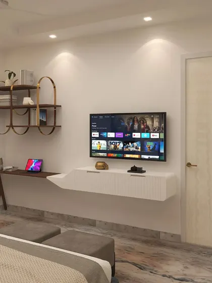 The functional side of the bedroom includes a floating TV unit, a sleek study desk, and open shelving for books and decor.