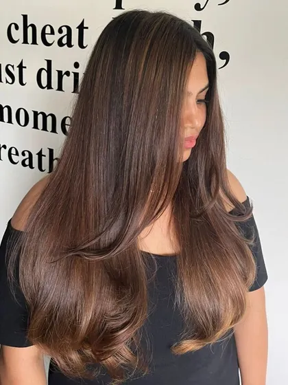 Embracing the artistry of balayage with this smooth, straight style that shows off the color blend.