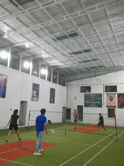 The court is alive with energy! A full view of a doubles match with players covering all corners.