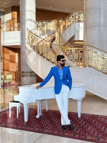 Make a vibrant statement with our electric blue linen blazer. Featuring wide lapels and handcrafted details, this jacket is set against a luxurious backdrop, showcasing a lifestyle of elegance and confidence.