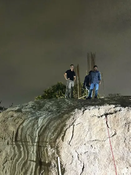 Our team atop the main boulder that anchors the Lurra House. The project is designed around this distinctive natural feature, making the rock an integral part of the home's identity.