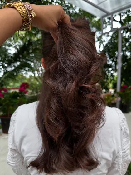 A classic chocolate brown color with cascading layers, pulled back to show the texture.