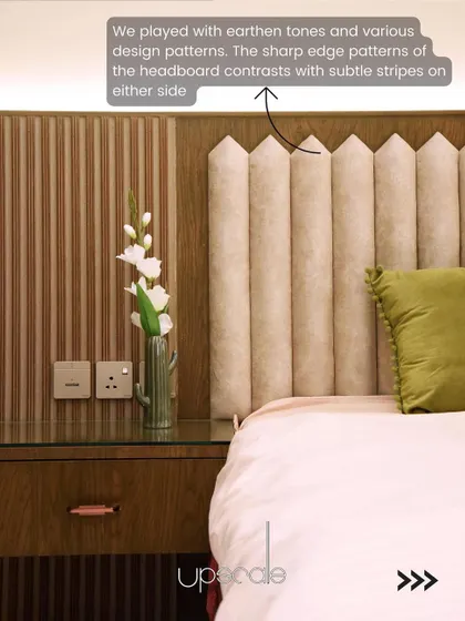 We played with contrasting patterns in this headboard design, where the sharp, custom-shaped edges of the upholstery meet the subtle vertical stripes of the wall panel.