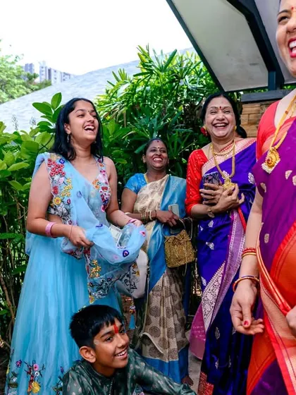 The best moments are often unposed. This photo from a thread ceremony captures the pure, spontaneous laughter shared between family members during a sacred and joyous occasion.