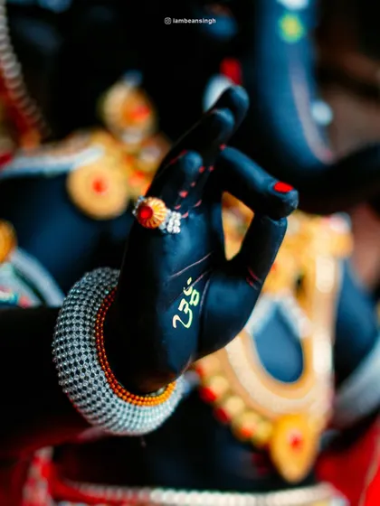This image focuses on the 'mudra' of the Ganpati idol's hand, a gesture of blessing and reassurance. It’s a symbol of the peace and protection that devotees seek from Lord Ganesha.
