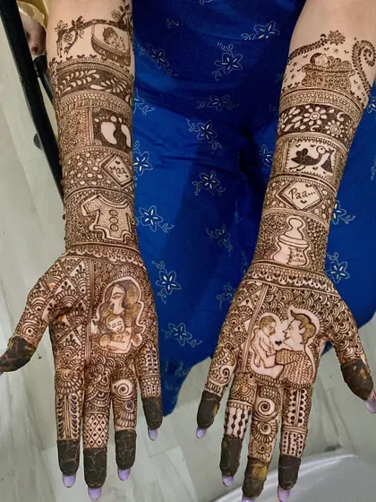 An incredibly detailed maternity mehndi design. It tells a complete story with portraits of the parents, baby footprints, a feeding bottle, and other symbols of the journey to parenthood.