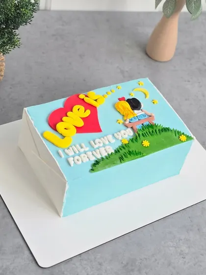 A different angle of the "Love Is..." cake, showing its clean, sharp edges.