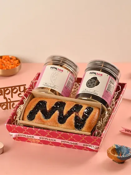 The 'Rangmanch' hamper is a vibrant stage of flavors. This customizable box includes a Blueberry Marble tea cake and two jars of our signature eggless cookies.