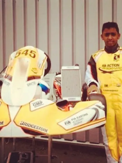 A portrait of our driver with his internationally-prepped kart, showcasing the professional standards we maintain.