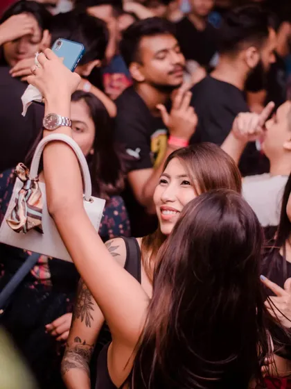 A guest taking a selfie in the middle of a packed dance floor in Guwahati.