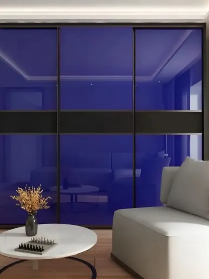 This sliding wardrobe features bold blue lacquered glass panels for a vibrant pop of color. It's a great way to introduce personality into a room while maintaining a sleek and modern aesthetic.
