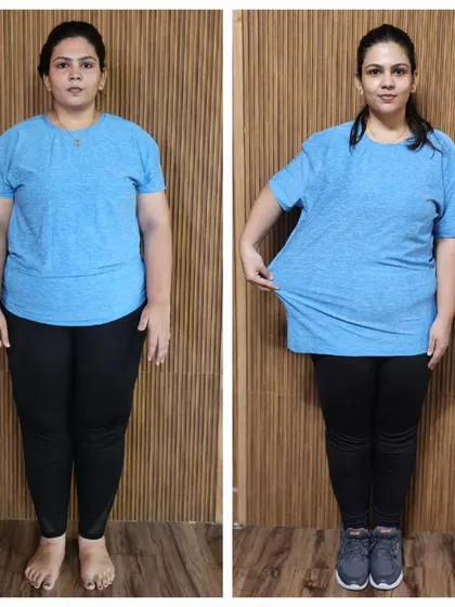 Another shot showing the client pulling at her old t-shirt, a tangible measure of her successful fat loss.