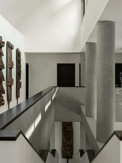 Interior views of the gallery-like spaces, where concrete columns and walls create a neutral yet powerful backdrop for art. The play of light from skylights and windows animates the surfaces.