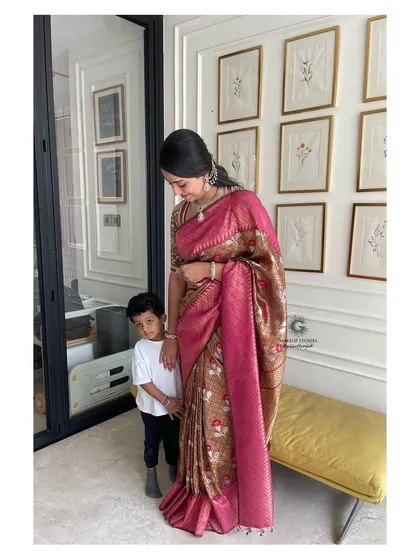 A sweet moment between Revathi and her son. Her makeup is soft and natural, perfect for a family occasion, yet still looks polished and put together.