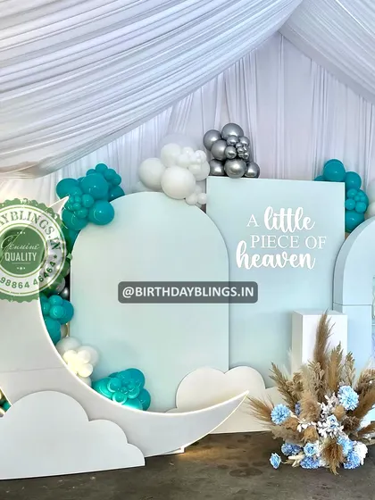 A close-up of the moon and cloud cutouts, showing the dreamy details of the baby shower theme.