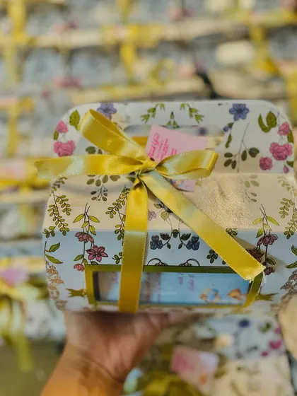 Another view of the floral baby shower hamper, tied with a beautiful gold ribbon.