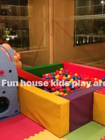 A compact rainbow setup perfect for smaller indoor spaces, featuring a ball pit with a climber and slide.