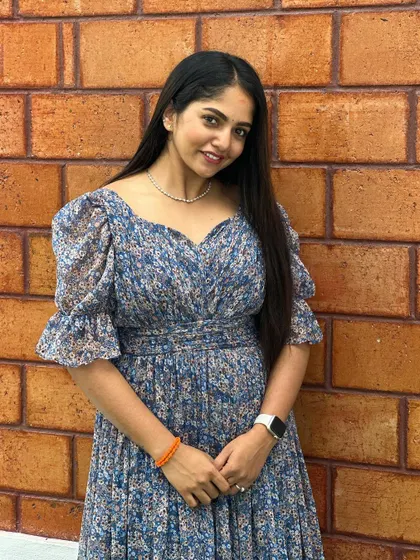 A close-up of the client in her pretty blue floral dress.