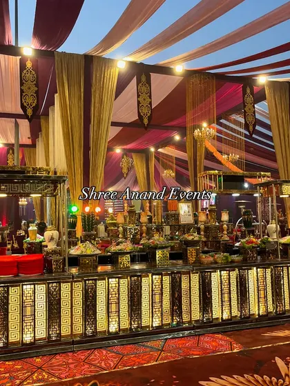 Another angle of the grand buffet, this image highlights the intricate geometric patterns on the illuminated counter front. The setup is designed to be a visual centerpiece of the event.
