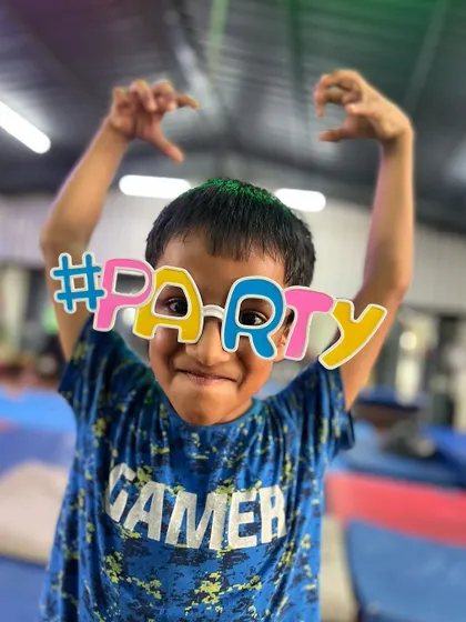 This little gamer is ready to party. His playful pose and fun glasses show he's here for a good time.