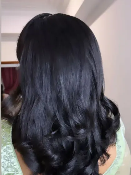 A simple open hairstyle with soft, layered curls, perfect for any party or casual event.