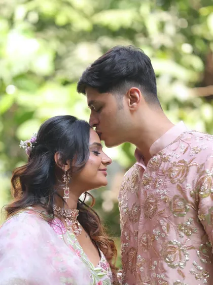 An intimate and beautiful shot. The bride's soft makeup, with its rosy tones and gentle shimmer, looks flawless even in natural outdoor lighting.