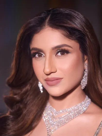 A close-up of the Sangeet glam. The focus is on the dramatic eyes and flawless skin, paired with a sophisticated nude lip.