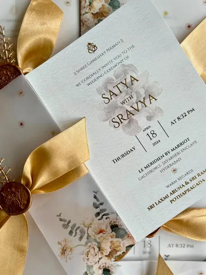A close-up of the S&S wedding invitation, highlighting the delicate watercolor floral design and the elegant script.