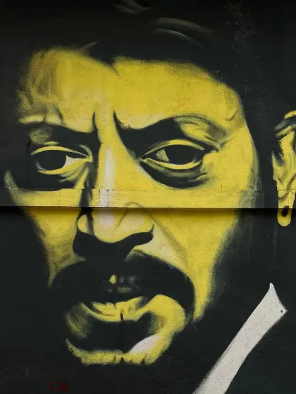 A striking yellow and black stencil art portrait of actor Irrfan Khan, adding to the artistic vibe of Bandra's streets.