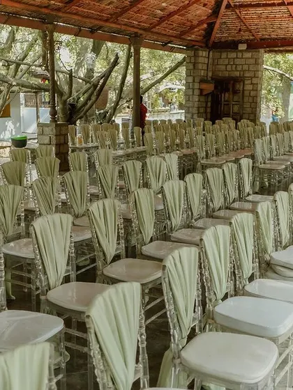 The guest seating for the wedding ceremony, with chairs neatly arranged under a rustic tiled roof.