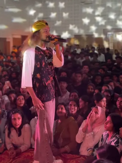 A great shot of me on the mic, surrounded by a massive crowd of students looking on.