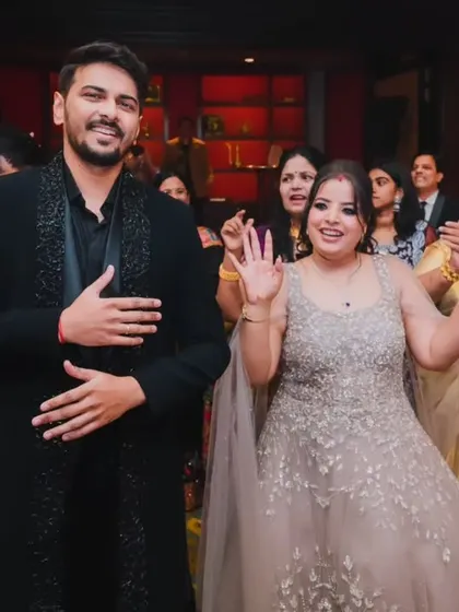 The couple dancing their way into the reception, surrounded by the happy faces of their friends and family.