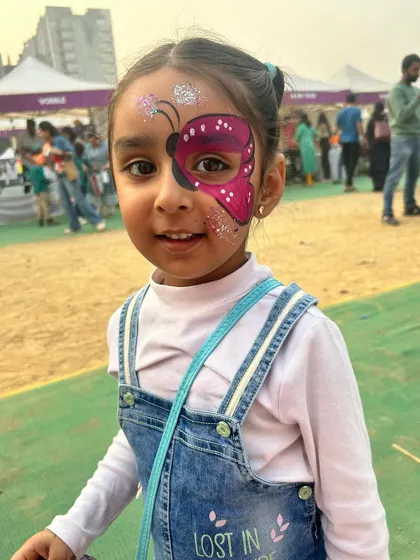 A beautiful butterfly mask for a beautiful girl at the Kukdukoo Fest. The glitter adds that extra touch of magic that every child loves.