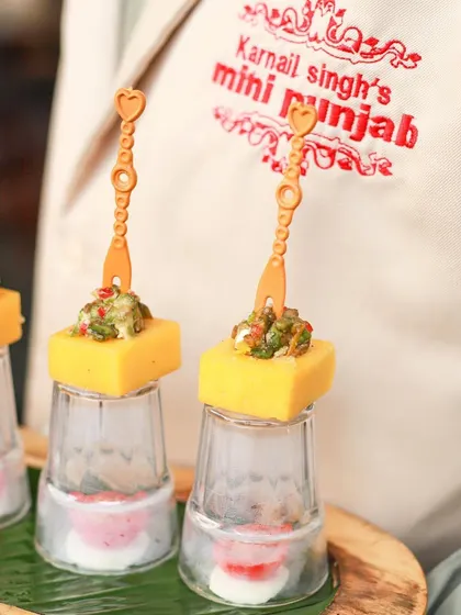 A close-up of our Cheddar Cups with Avocado Feta, showcasing the intricate presentation and our brand logo on the server's uniform. We take pride in every detail, from the food to the service.