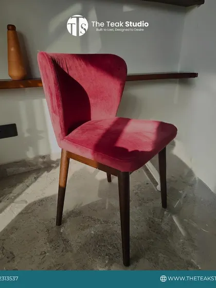 A classic dining chair with a twist. This piece features a solid teakwood frame, a comfortable seat upholstered in a vibrant pink velvet, and a simple, elegant silhouette that adds a pop of color to any dining space.