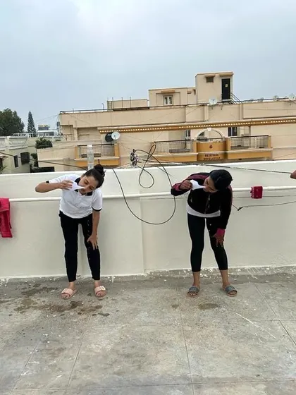 Students learning the proper posture for draining excess water after performing Jala Neti. This final step is crucial for completing the practice correctly and comfortably.