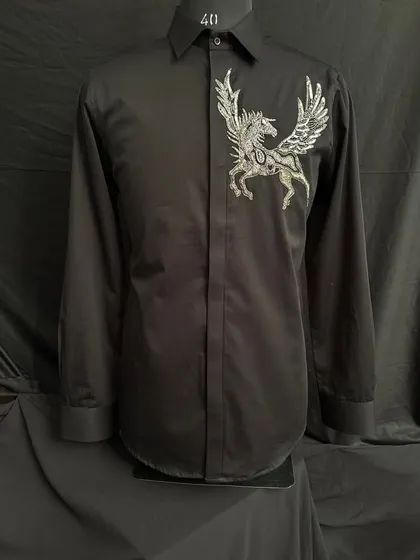 A classic black shirt is given a mythical twist with the addition of a silver-embroidered Pegasus on the chest. It's a piece that combines timeless style with a touch of fantasy.