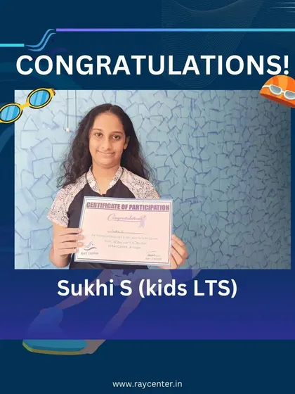 Sukhi S proudly holds her certificate, marking her successful completion of the swimming program.
