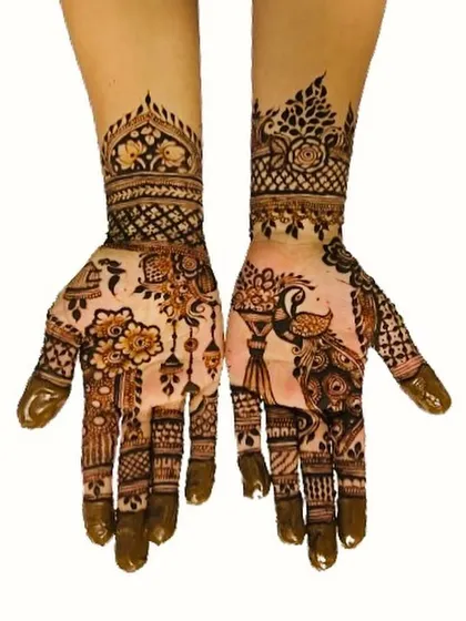 A classic and elegant henna design featuring a beautiful peacock on one palm and a vase of flowers on the other. The wrists are adorned with intricate cuff patterns, perfect for any festive occasion.