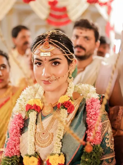 A candid shot from the ceremony, showing the bride's beautiful and authentic look in the midst of the rituals.