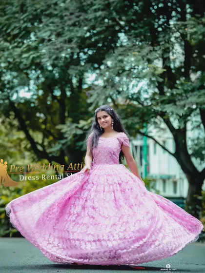 A pink lace ball gown with a full, pleated skirt that creates a beautiful shape, especially when in motion.