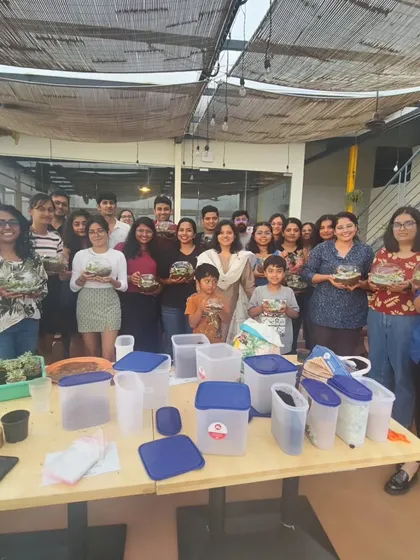 A proud group shot of all the participants from a packed terrarium workshop. It's a joy to foster social connections through the art of terrarium making.