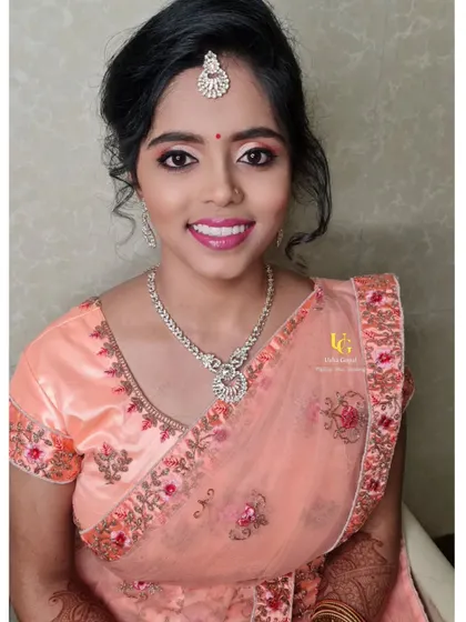 Swathi looking lovely with a soft glam makeover for a family event. The peach and pink tones in her makeup perfectly match her embroidered saree.