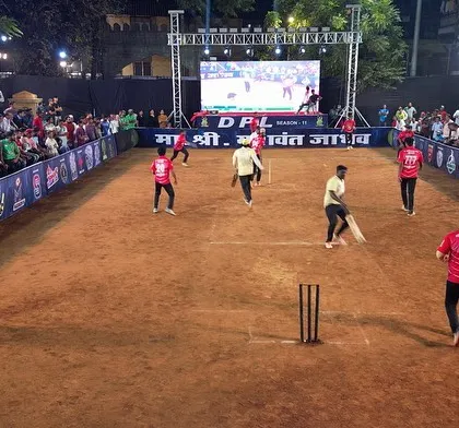 A wide-angle view of a match in progress at the DPL tournament. The large LED screen in the background shows live action, while the entire ground is evenly lit for perfect visibility.