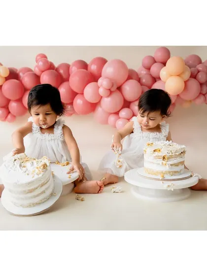 The twin girls getting ready to dig into their individual birthday cakes.
