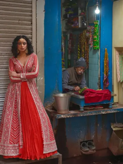 A modern take on bridal wear with this red jacket-style lehenga. The long, heavily embroidered jacket over a simple skirt is a chic and contemporary choice for a reception or sangeet.
