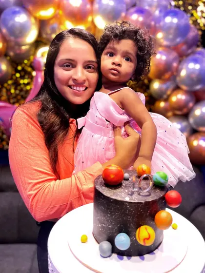 A lovely client photo featuring my space-themed cake. It's wonderful to see my creations bringing smiles to faces.
